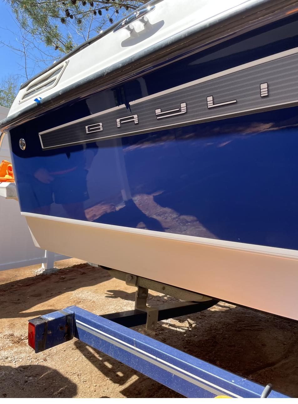 Same Bayliner hull after compound and polish — mirror finish